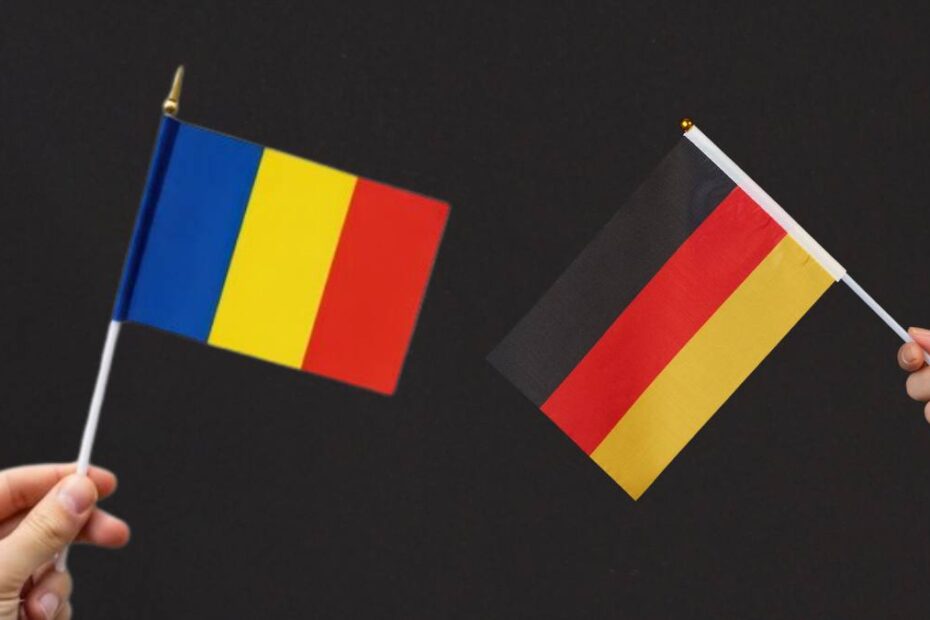 A venit din România în Germania și a început de la zero. În imagine, un concept de integrare, doua mâini flutură steagul românesc și cel german