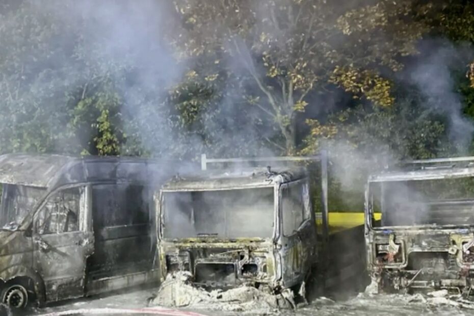 Camioane și o autoutilitară distruse de incendiu, cu fum deasupra vehiculelor, la centrul MAN din Leipzig